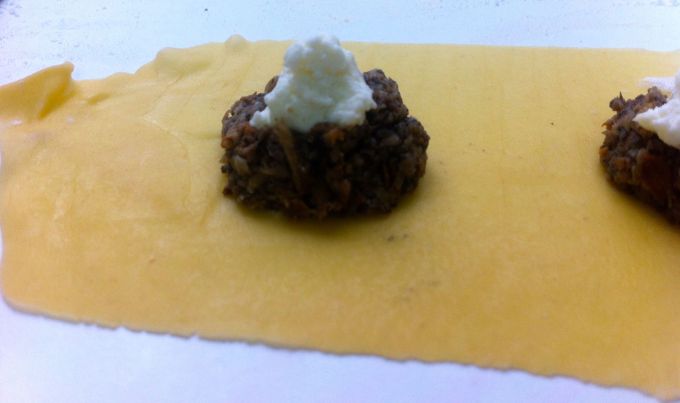 A dollop of homemade ricotta atop mushrooms. 